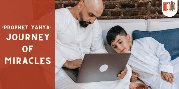 Father and son engrossed in a laptop, exploring the miraculous journey of Prophet Yahya.